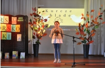 Dziwczynka na scenie, w tle napis kurcze blade