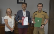 2 mezczyzn i jedna kobieta. Mezczyzni trzymaja teczki 